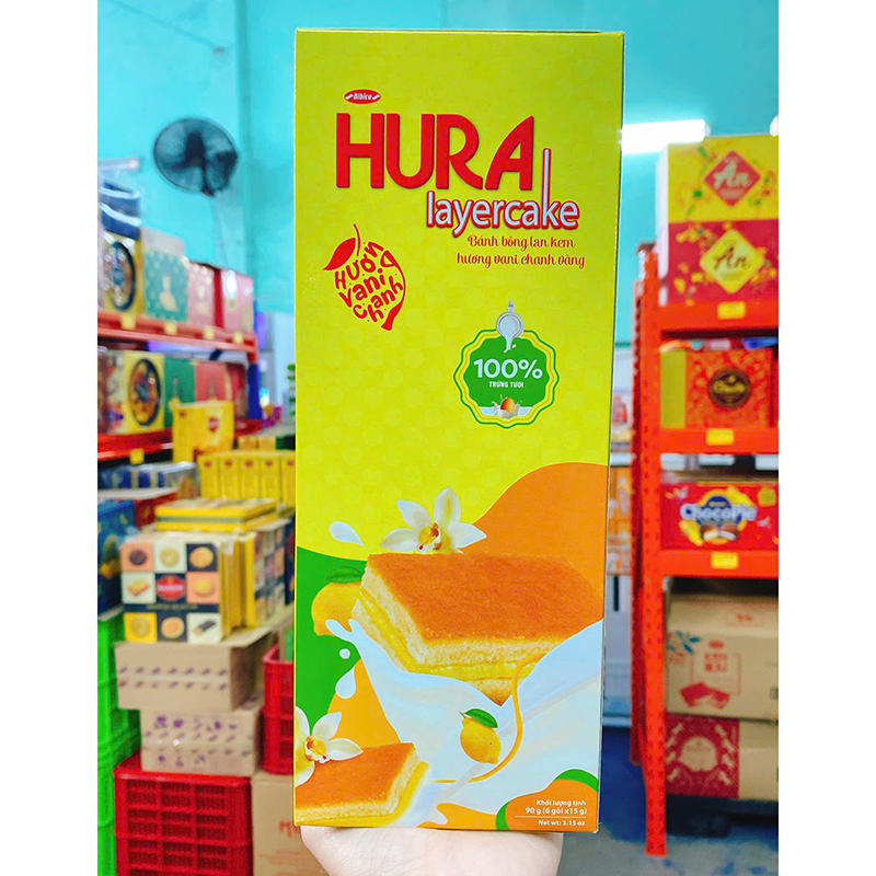 Bánh Bông Lan Kem Hương Vani Chanh Vàng HURA 90g (6 Gói x 15g) Bánh Bông Lan Kem Hương Vani Chanh Vàng HURA 90g (6 Gói x 15g)